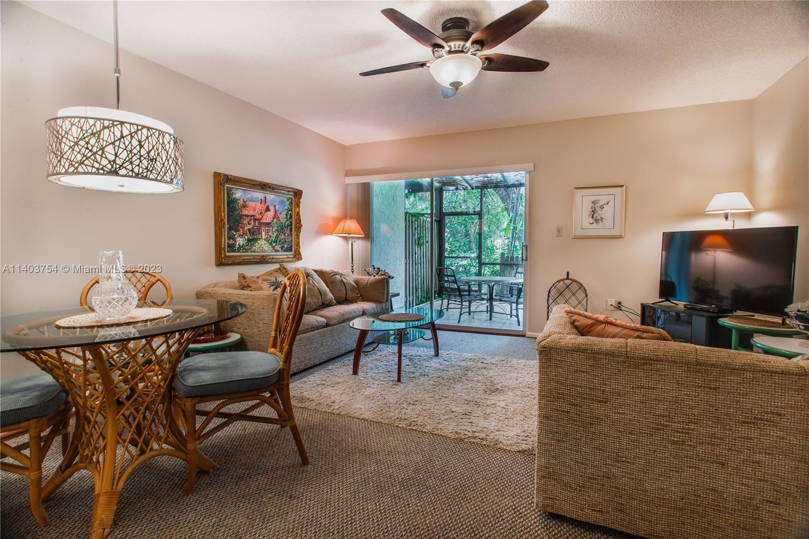 894 Southwest 9th St Circle, Unit 8 Boca Raton, FL 33486 - Photo 1 of 24 a living room with furniture and a flat screen tv