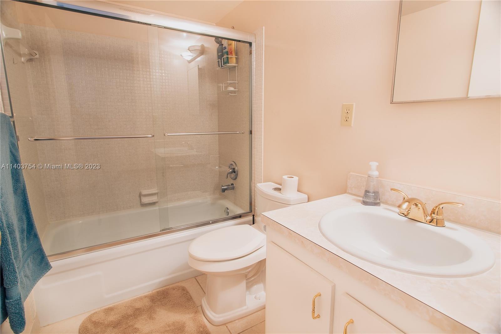 894 Southwest 9th St Circle, Unit 8 Boca Raton, FL 33486 - Photo 15 of 24 a bathroom with a sink toilet and shower