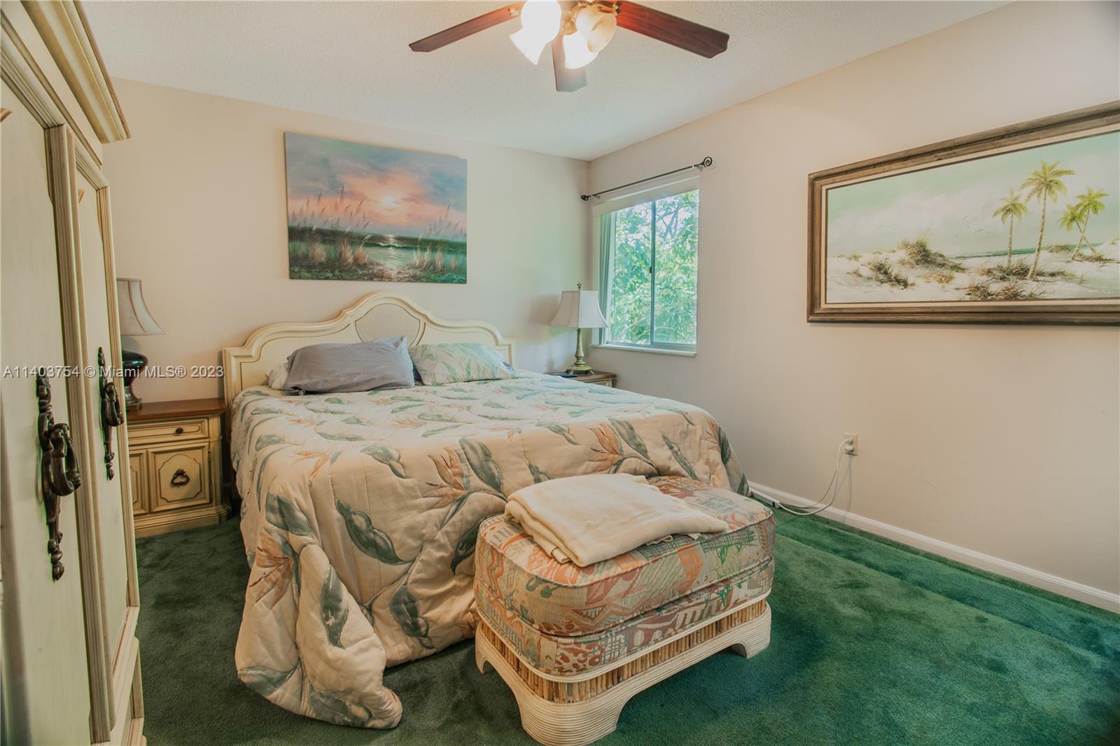 894 Southwest 9th St Circle, Unit 8 Boca Raton, FL 33486 - Photo 16 of 24 a bedroom with a bed and a painting on the wall