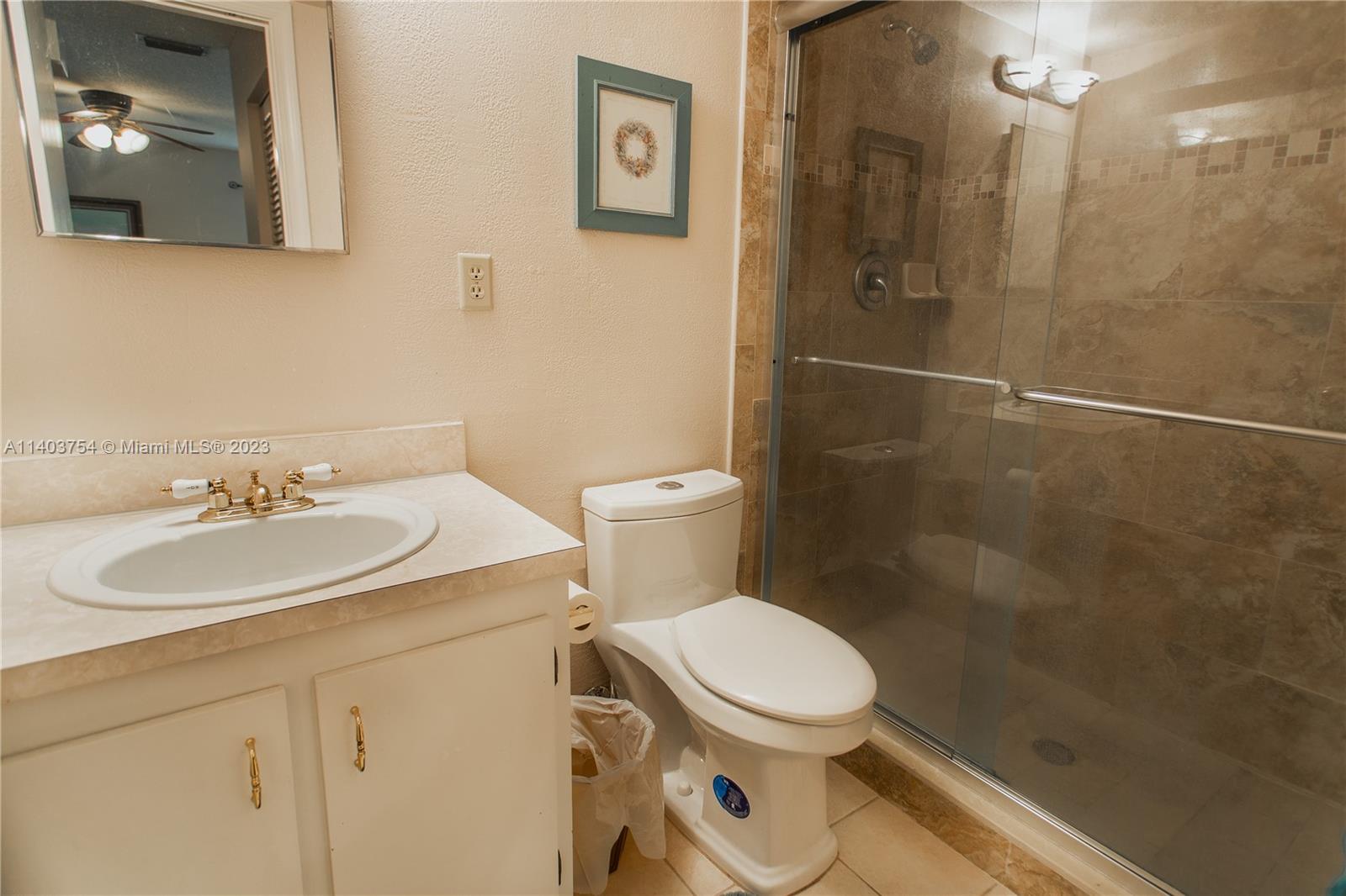 894 Southwest 9th St Circle, Unit 8 Boca Raton, FL 33486 - Photo 20 of 24 a bathroom with a sink toilet and shower