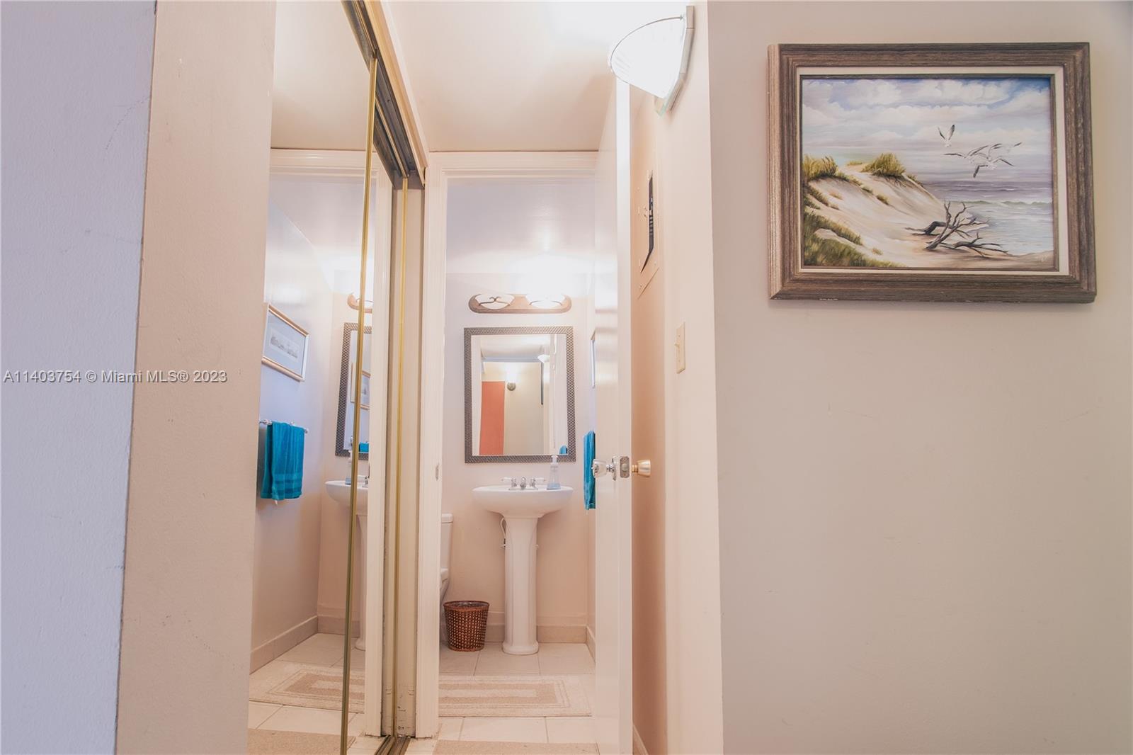 894 Southwest 9th St Circle, Unit 8 Boca Raton, FL 33486 - Photo 9 of 24 a view of a hallway with paintings on the wall