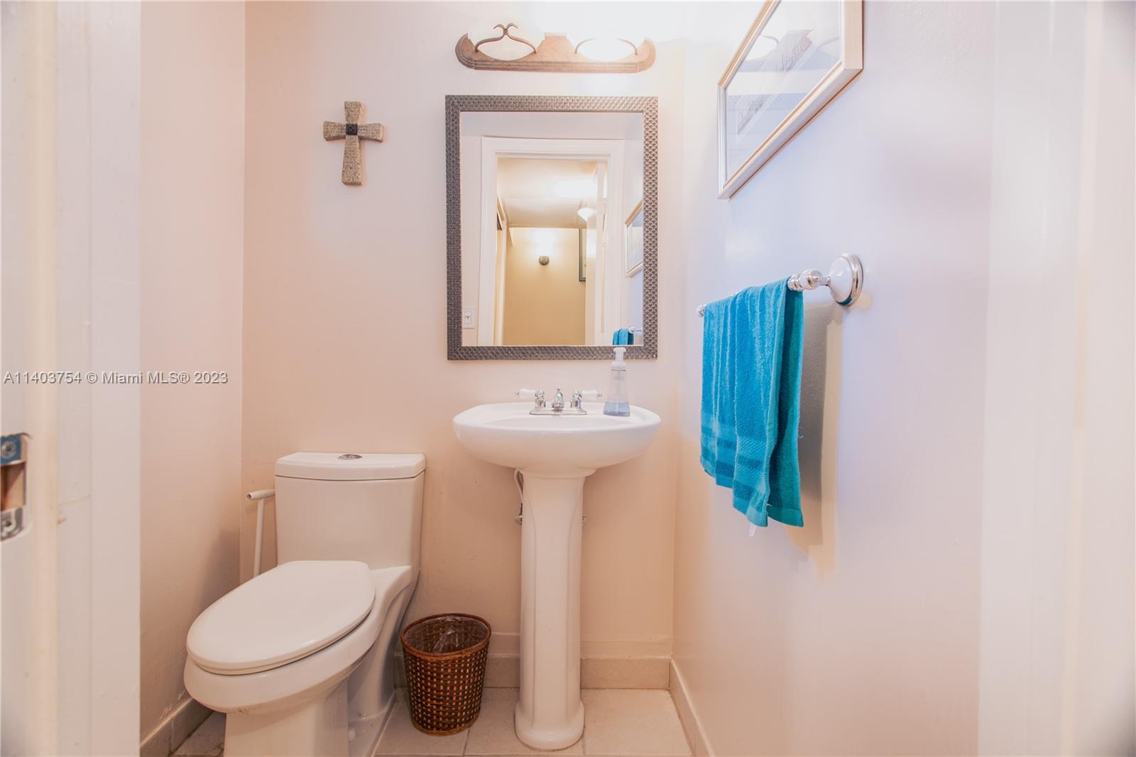 894 Southwest 9th St Circle, Unit 8 Boca Raton, FL 33486 - Photo 10 of 24 a bathroom with a toilet sink and mirror