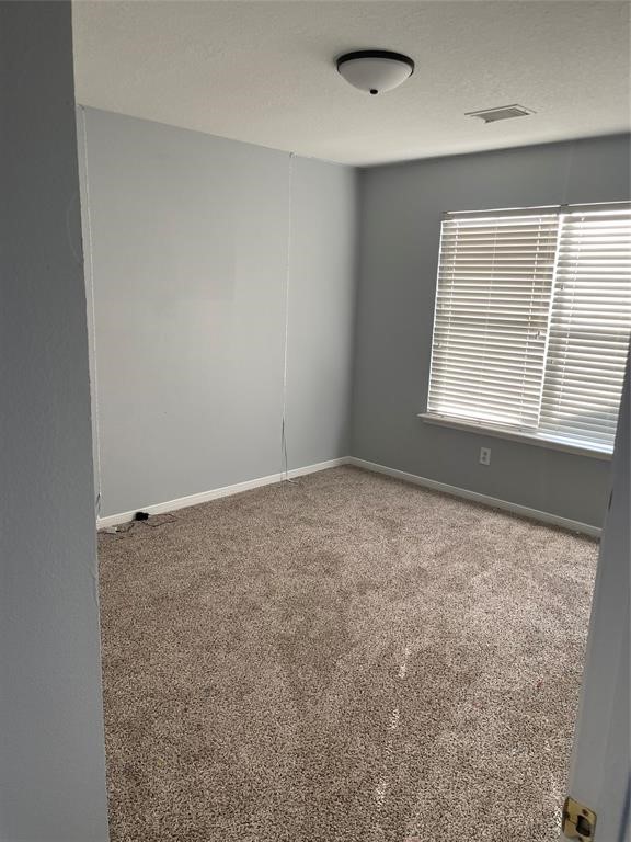 2103 Ragland Drive Houston, TX 77067 - Photo 15 of 18 an empty room with a empty space and windows
