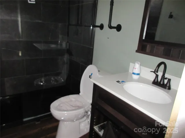 a white toilet sitting next to a bathroom sink