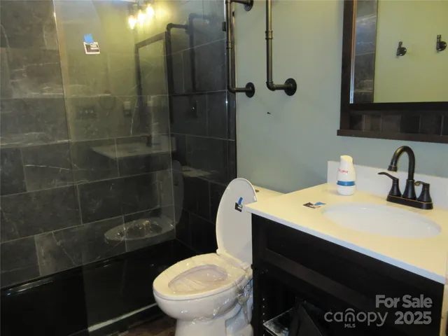 a bathroom with a sink a toilet and a mirror