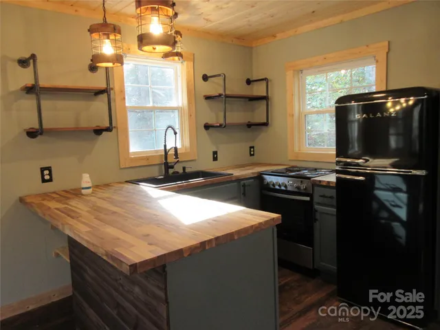 a kitchen with a sink a stove and a microwave