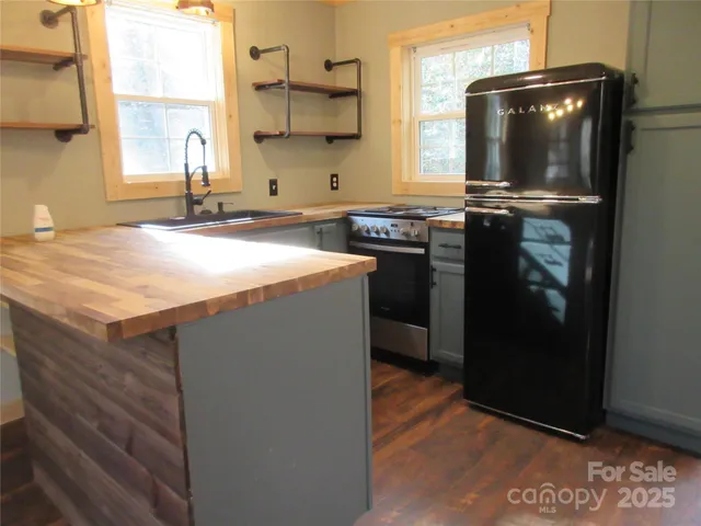a kitchen with a sink a stove and a refrigerator