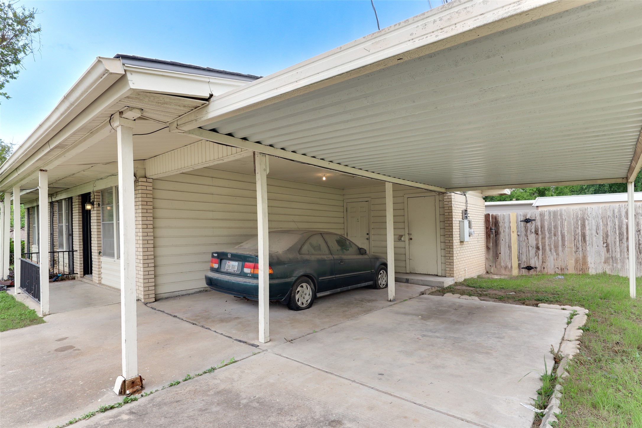 1800 Rhodes Road Austin, TX 78721 - Photo 3 of 14 a car parked in front of house