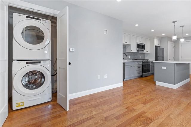 a view of a kitchen with a washer and dryer