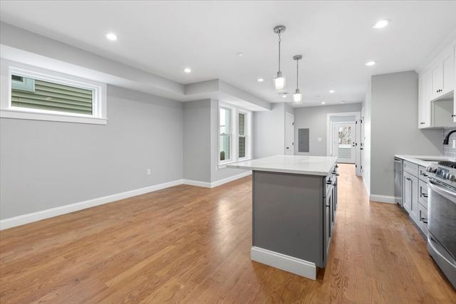 an open kitchen with a refrigerator and a stove