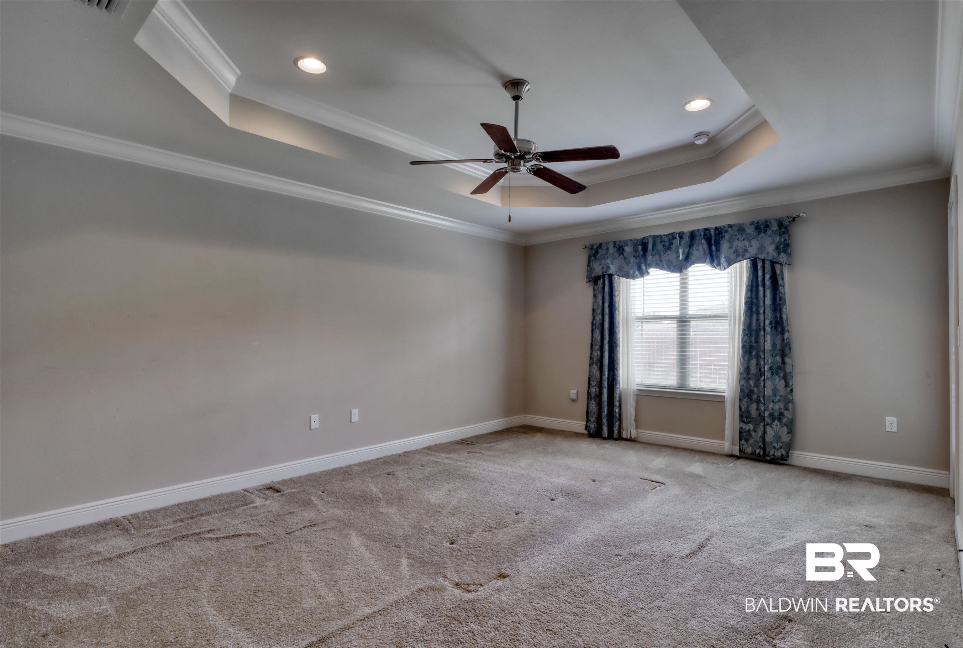 14794 Troon Drive Foley, AL 36535 - Photo 12 of 33 Empty room with crown molding, a raised ceiling, and baseboards