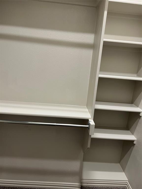 6041 Roper Road McKinney, TX 75070 - Photo 20 of 24 Built-in closet organization system featuring shelving and hanging rods