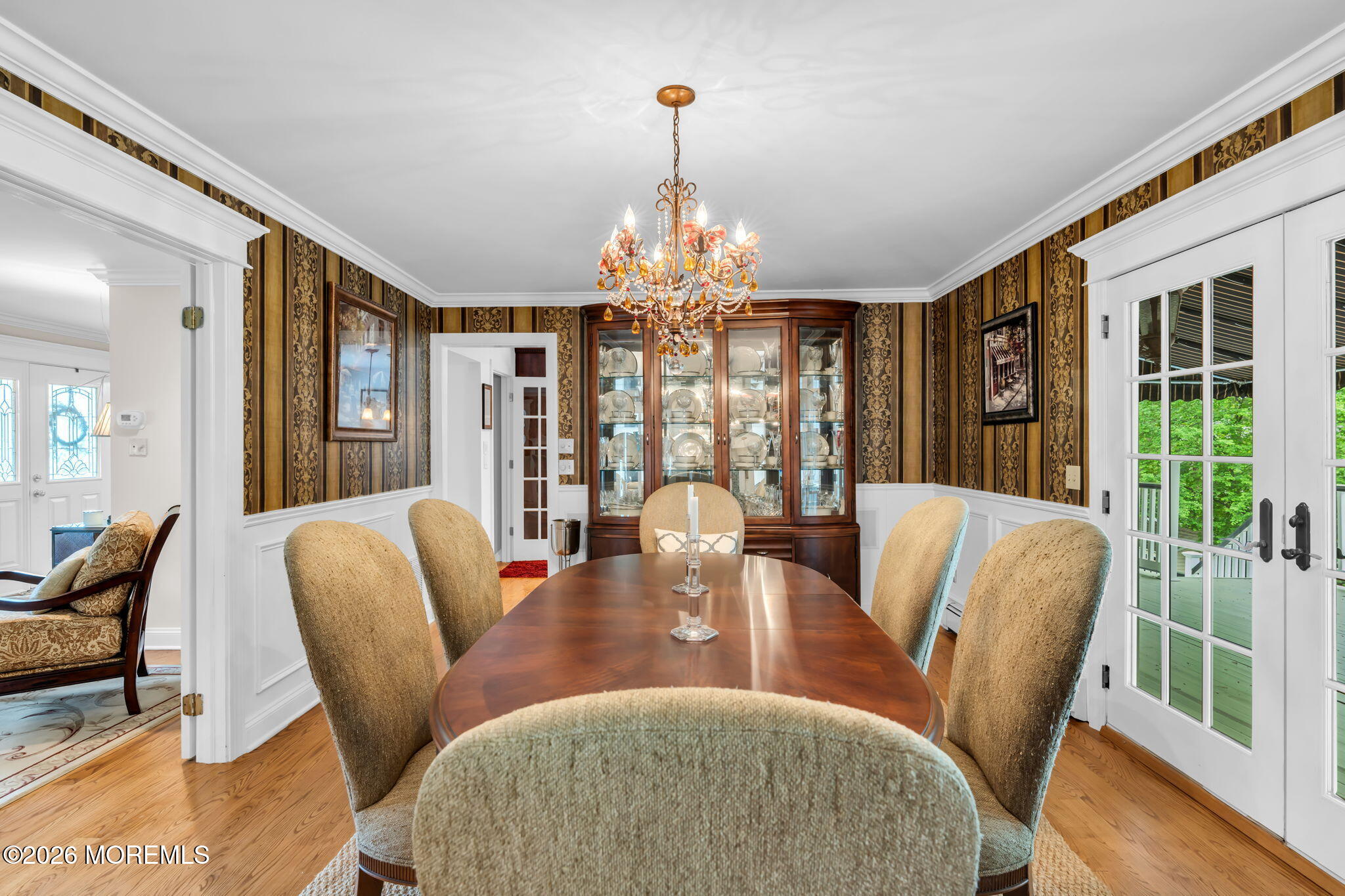 657 Valley Road Brielle, NJ 08730 - Photo 11 of 44 a dining room with furniture a chandelier and wooden floor