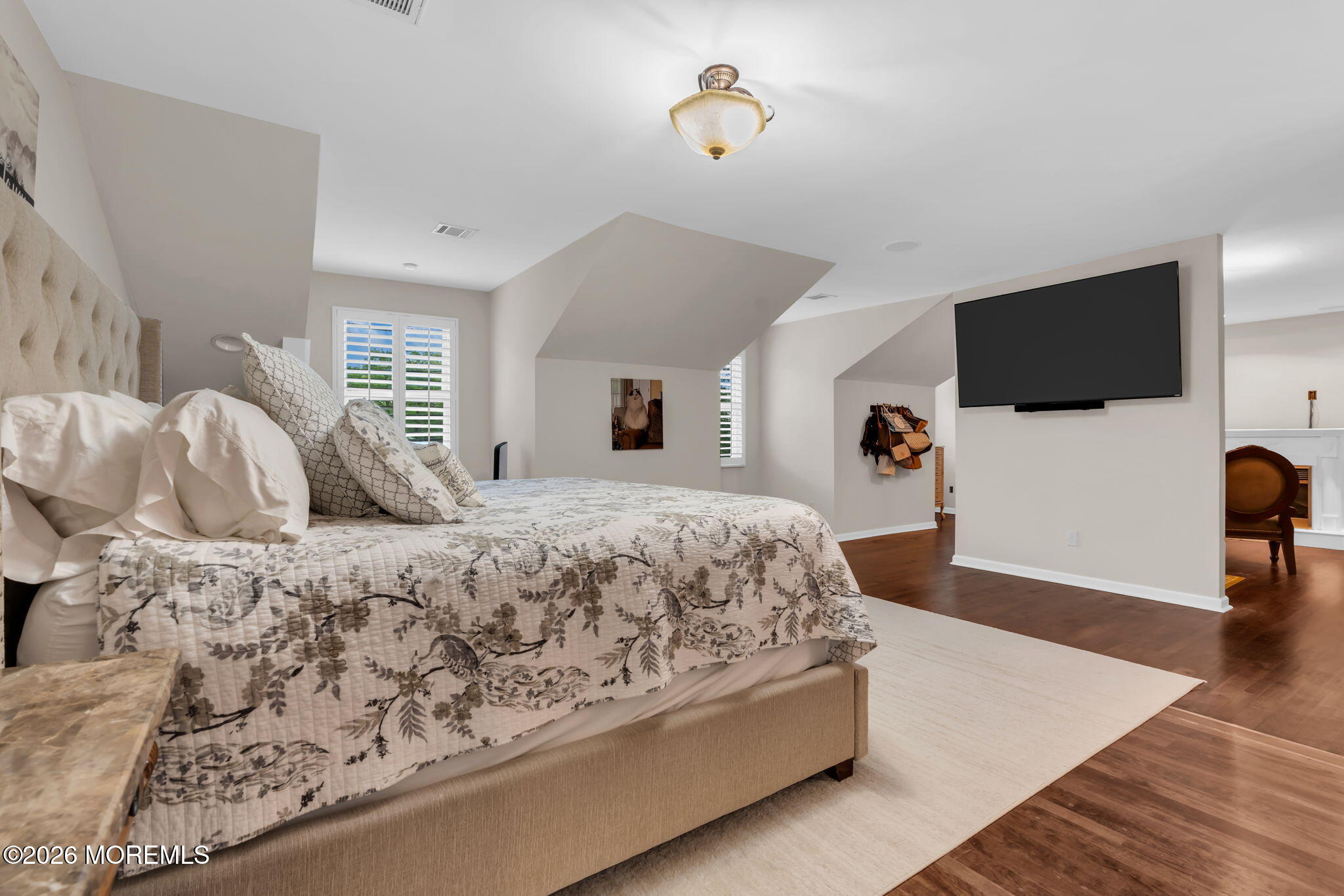 657 Valley Road Brielle, NJ 08730 - Photo 22 of 44 a spacious bedroom with a large bed and a flat screen tv