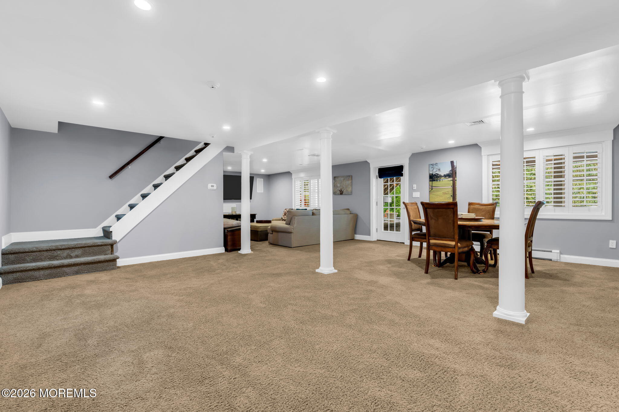 657 Valley Road Brielle, NJ 08730 - Photo 29 of 44 an empty room with furniture and a dining table with projector screen