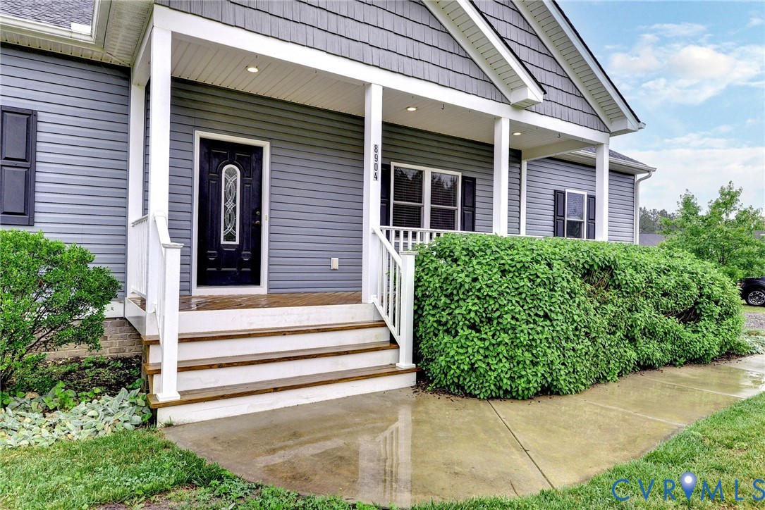 8904 Rock Cedar Road New Kent, VA 23124 - Photo 1 of 37 a view of a house with potted plants and a table and chairs