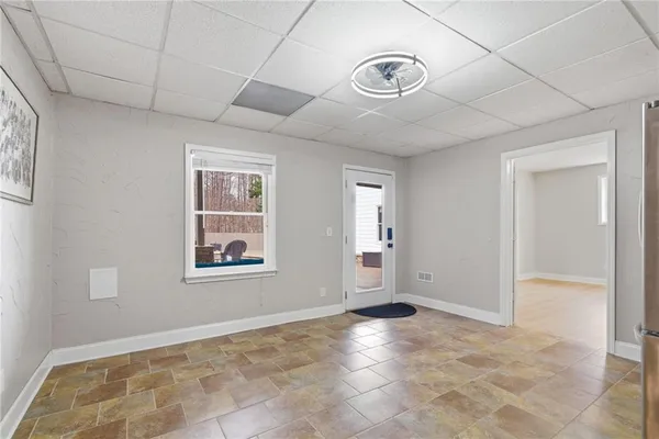 a view of empty room with wooden floor