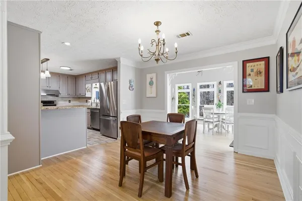 a view of a dining room with furniture and wooden floor