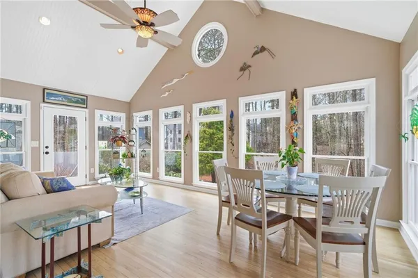 a bedroom with bed tv and window