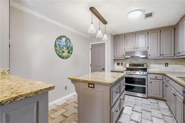 a kitchen with a stove and a sink