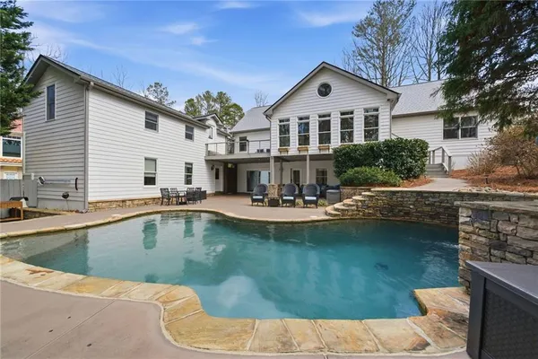 a view of a backyard with large trees