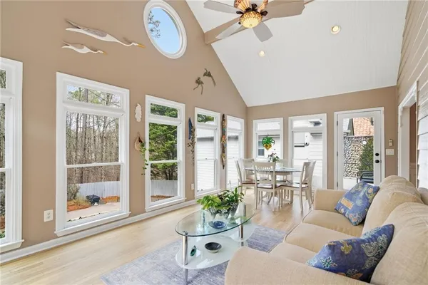 a living room with furniture a table and a large window