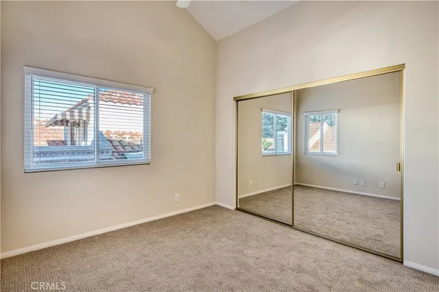 an empty room with windows and stairs