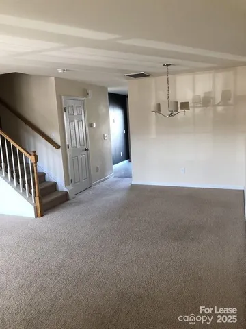 a view of empty room with stairs