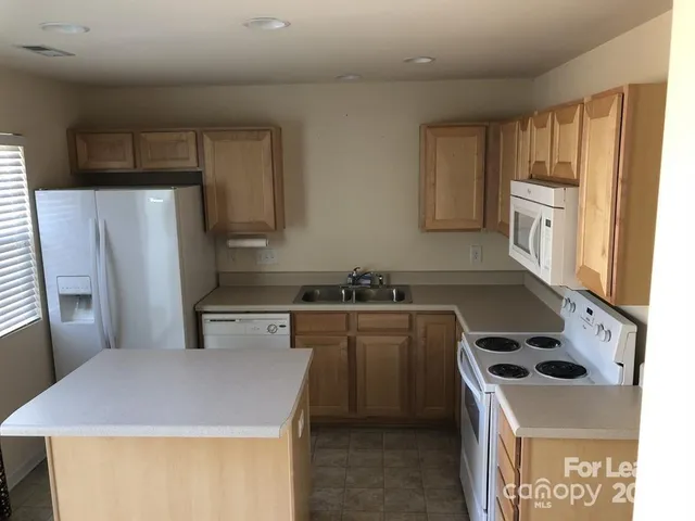 a kitchen with a sink a stove and refrigerator