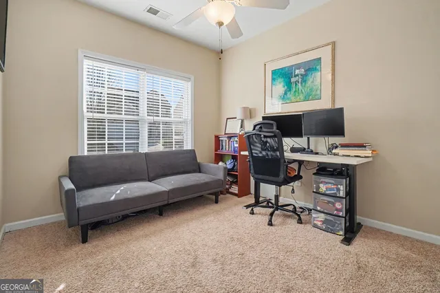 a view of a livingroom with workspace and a couch
