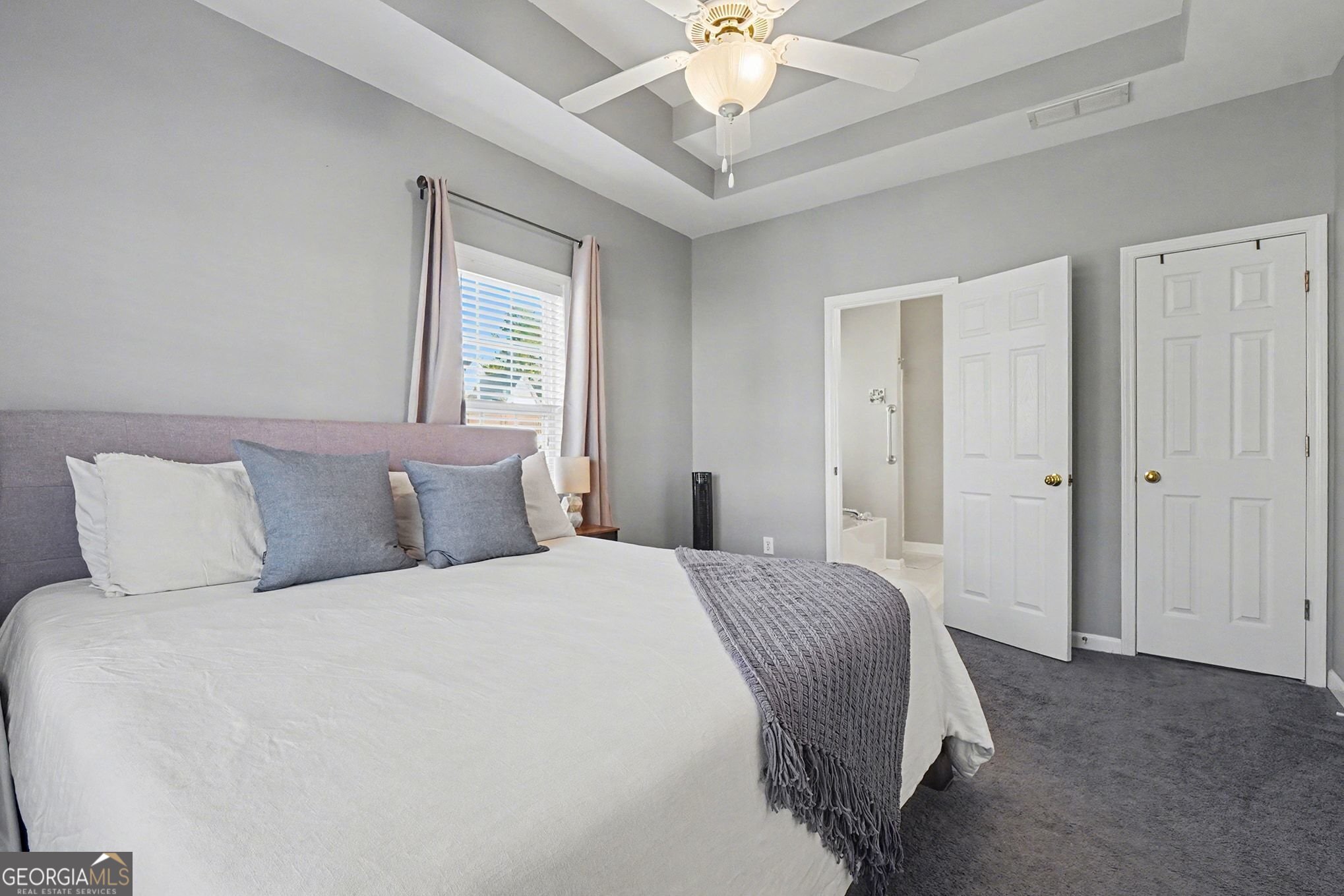 310 Turtle Pointe Drive Carrollton, GA 30116 - Photo 17 of 32 a bedroom with a large bed and a chandelier