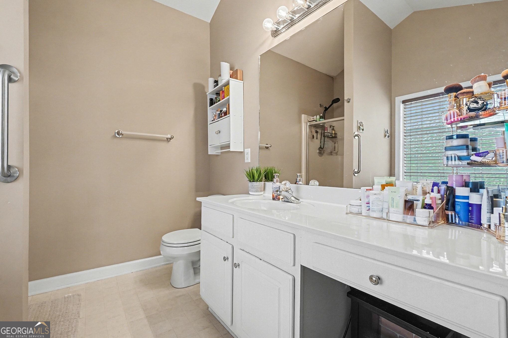 310 Turtle Pointe Drive Carrollton, GA 30116 - Photo 19 of 32 a bathroom with a sink a toilet and a mirror