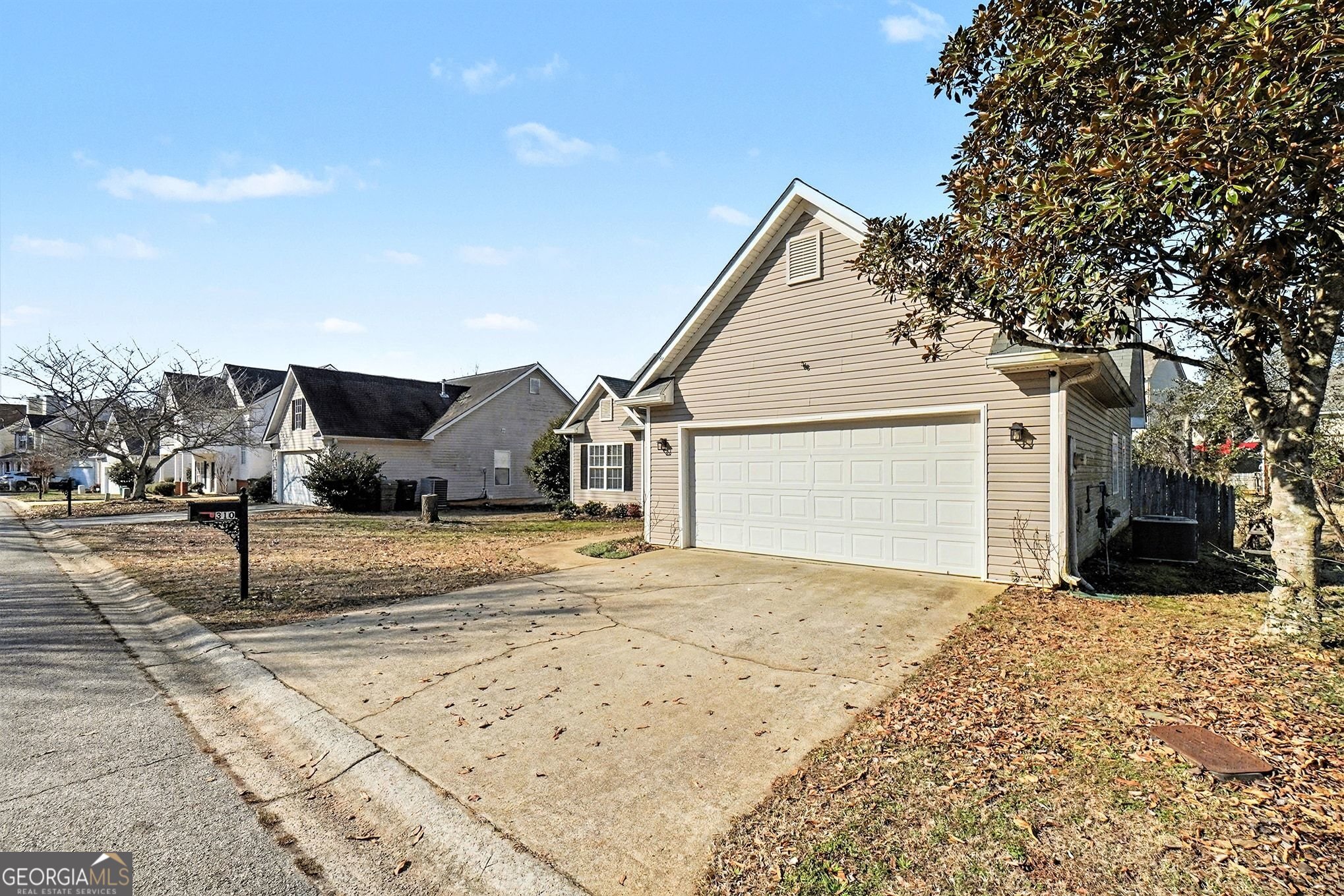 310 Turtle Pointe Drive Carrollton, GA 30116 - Photo 2 of 32 a view of a white house with a outdoor space