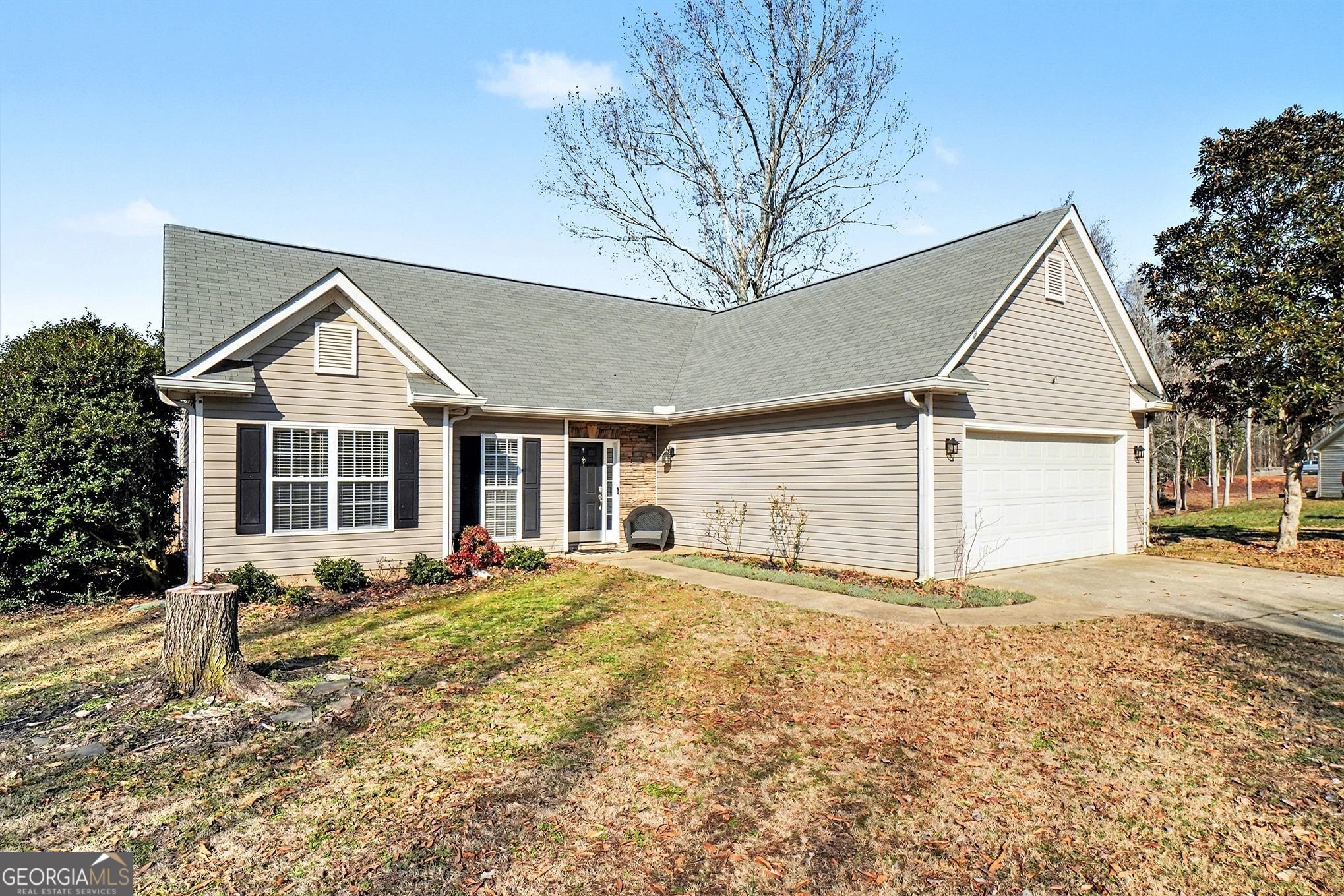 310 Turtle Pointe Drive Carrollton, GA 30116 - Photo 3 of 32 a front view of a house with a yard and garage