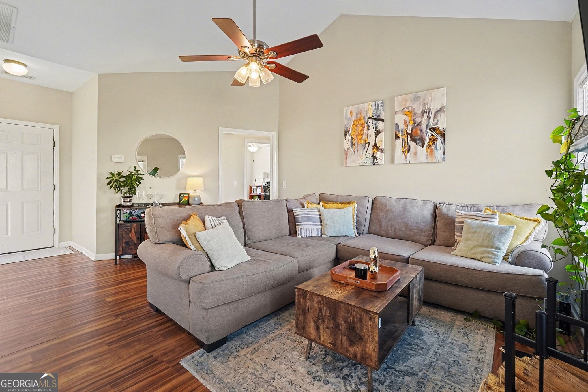 310 Turtle Pointe Drive Carrollton, GA 30116 - Photo 5 of 32 a living room with furniture and a chandelier