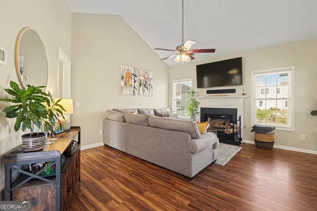 a living room with furniture a fireplace and a flat screen tv