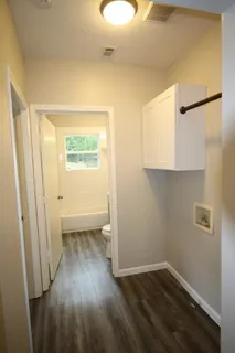 a view of a room with wooden floor and a window