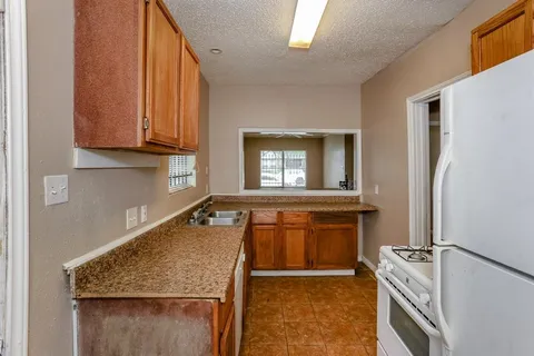 a kitchen with a refrigerator stove and sink