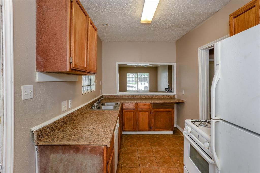2612 Isabella Street Houston, TX 77004 - Photo 8 of 34 a kitchen with a refrigerator stove and sink