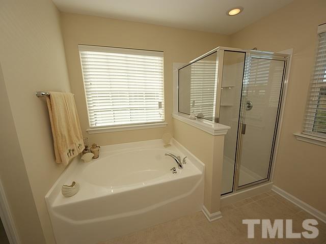 2705 Communion Court Raleigh, NC 27610 - Photo 13 of 24 a white bath tub sitting next to a window