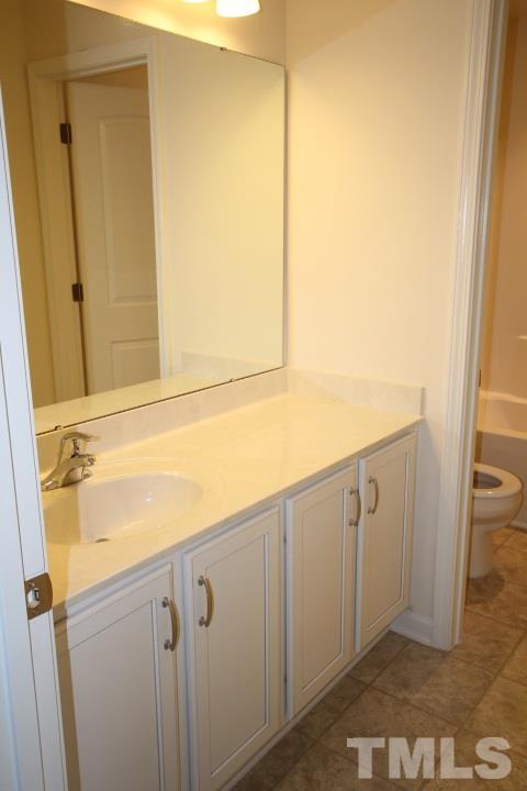 2705 Communion Court Raleigh, NC 27610 - Photo 22 of 24 a bathroom with a sink and a mirror