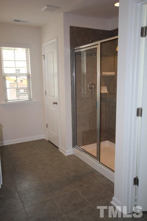 2705 Communion Court Raleigh, NC 27610 - Photo 24 of 24 a bathroom with a glass shower door