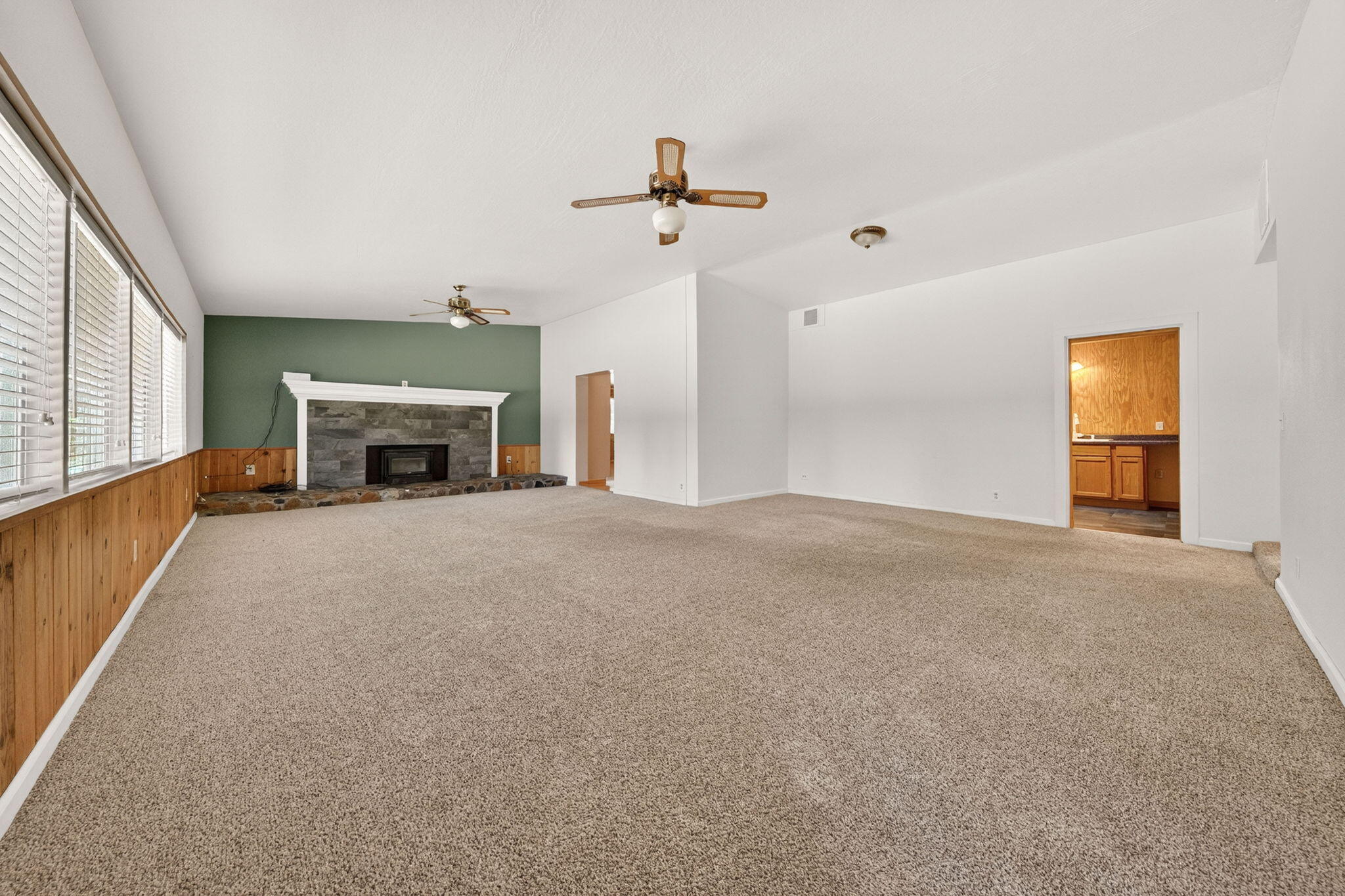 7682 Brokeoff Meadows Road Shingletown, CA 96088 - Photo 15 of 61 a view of empty room with fireplace and fan