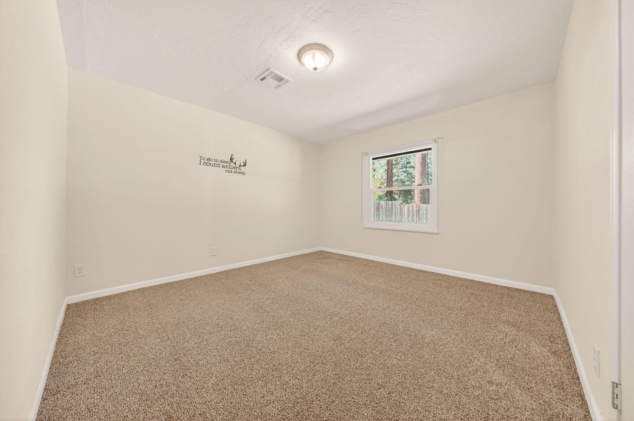 7682 Brokeoff Meadows Road Shingletown, CA 96088 - Photo 23 of 61 an empty room with a window