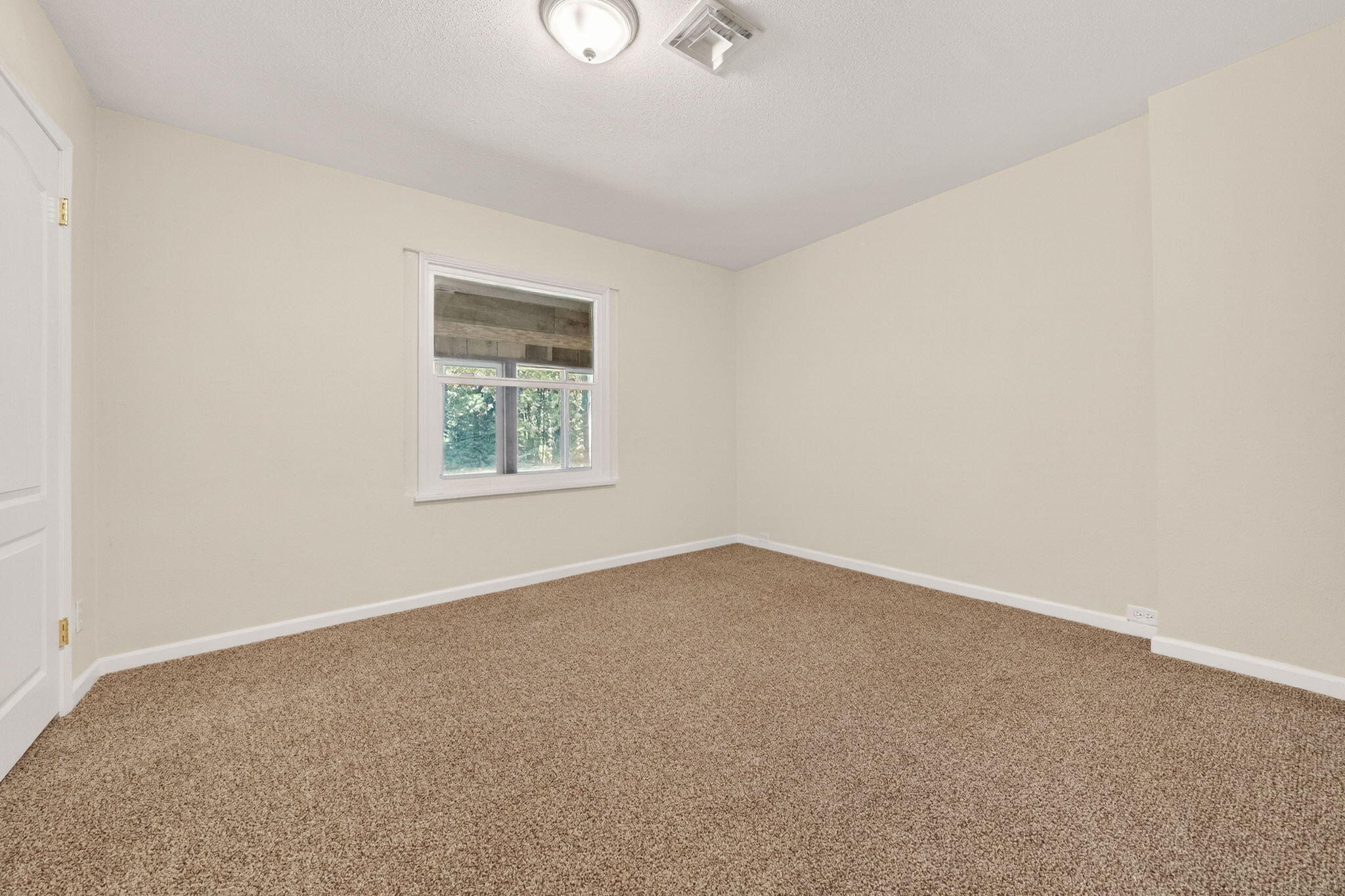 7682 Brokeoff Meadows Road Shingletown, CA 96088 - Photo 24 of 61 an empty room with a window