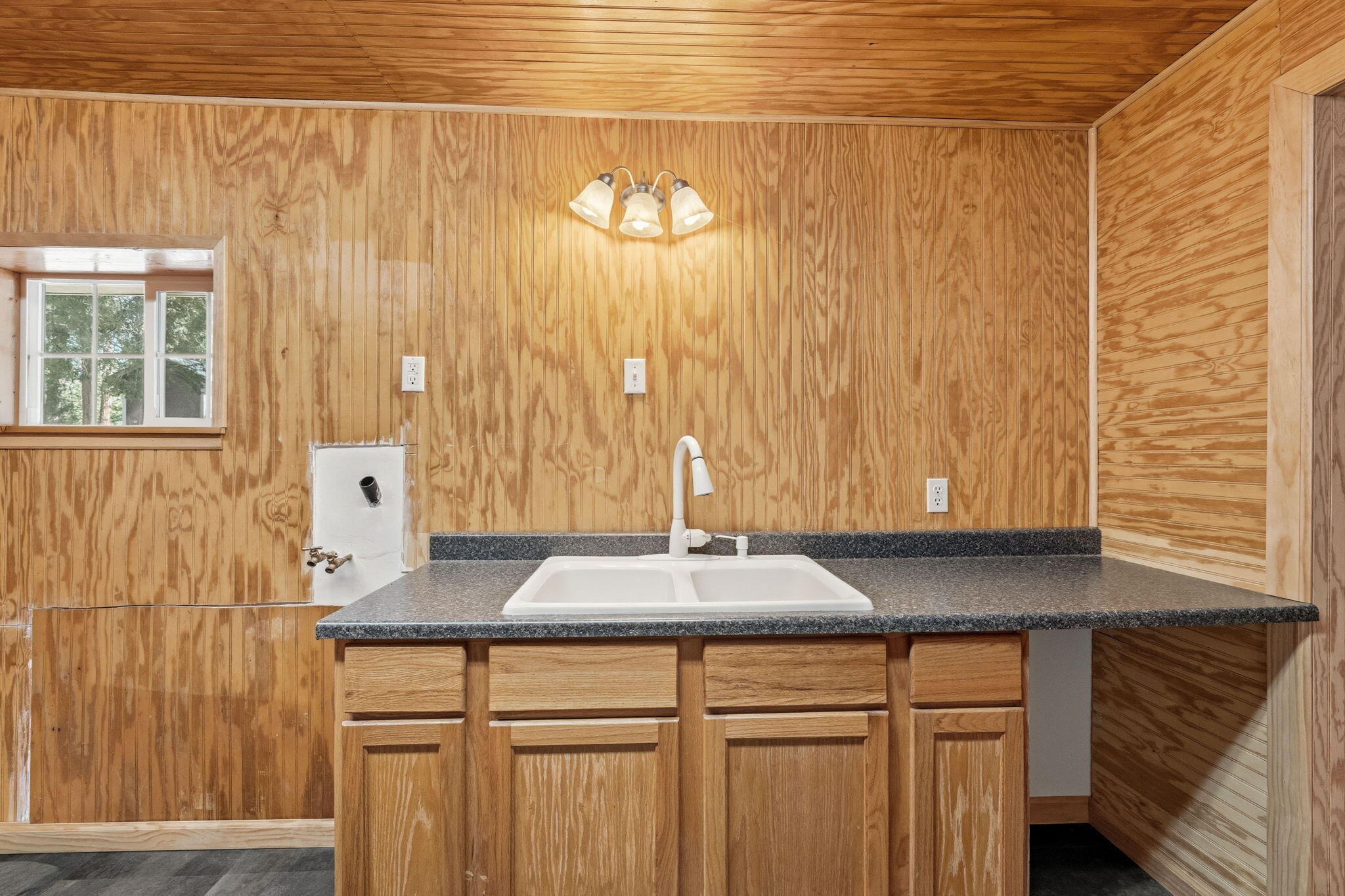 7682 Brokeoff Meadows Road Shingletown, CA 96088 - Photo 31 of 61 a kitchen with a sink and a mirror