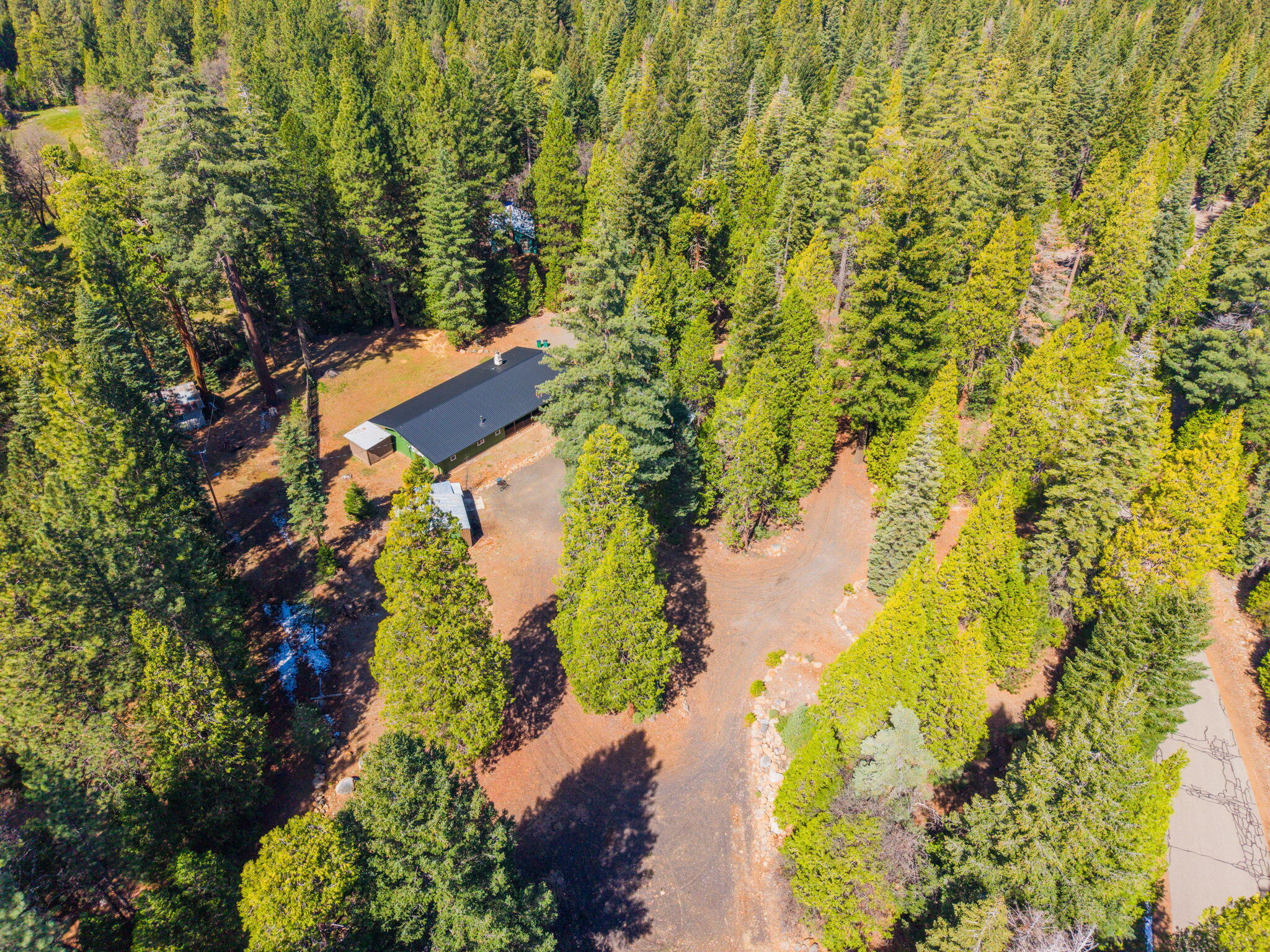 7682 Brokeoff Meadows Road Shingletown, CA 96088 - Photo 57 of 61 an aerial view of residential house with swimming pool and lawn chairs