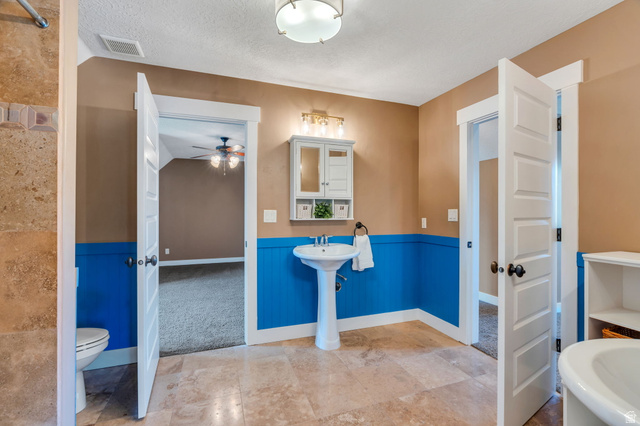1355 West 1000 South Mapleton, UT 84664 - Photo 43 of 74 Full bathroom with a wainscoted wall, a textured ceiling, and ceiling fan