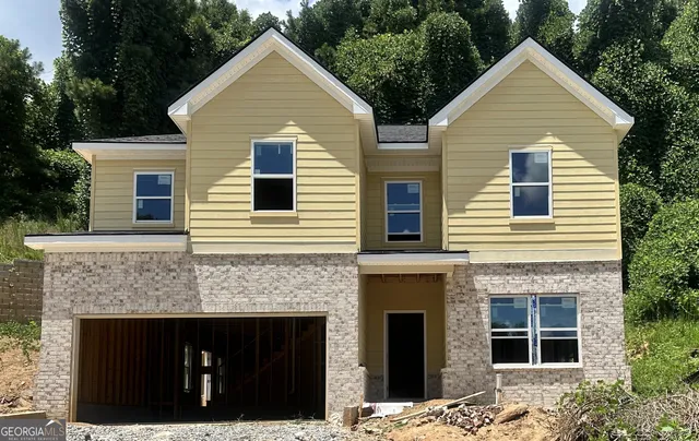 a front view of a house with a yard and garage
