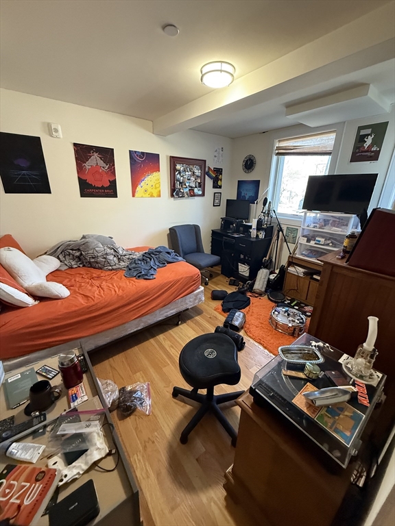 65 Cameron Street, Unit 3 Brookline, MA 02445 - Photo 11 of 16 a bedroom with furniture and a wooden floor